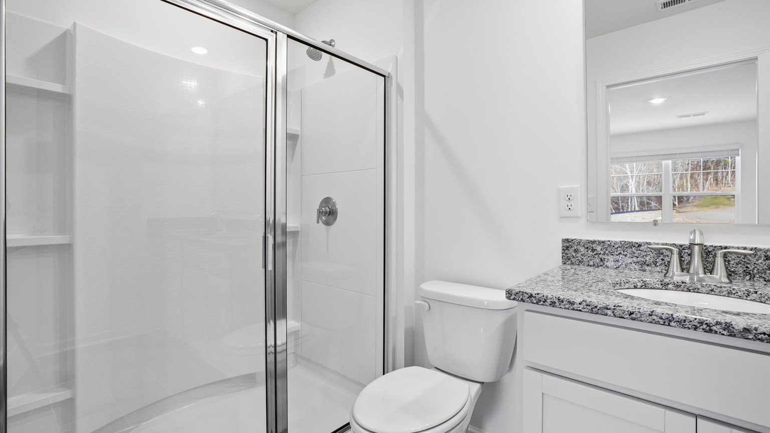 Primary bathroom with double vanity and walk-in shower