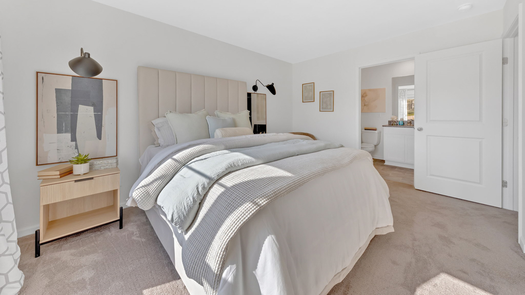 Primary bedroom with plush carpet floors and double light allowing windows
