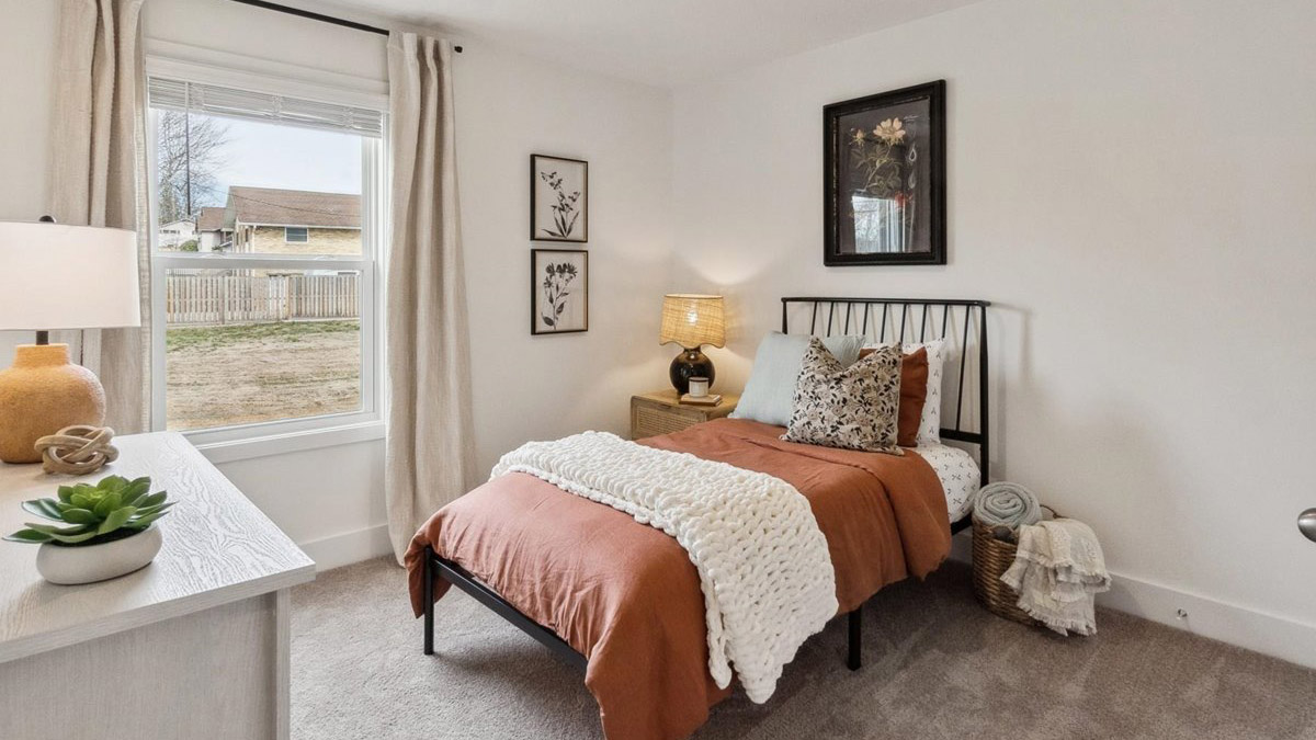 Bedroom with ample natural light and carpet floors