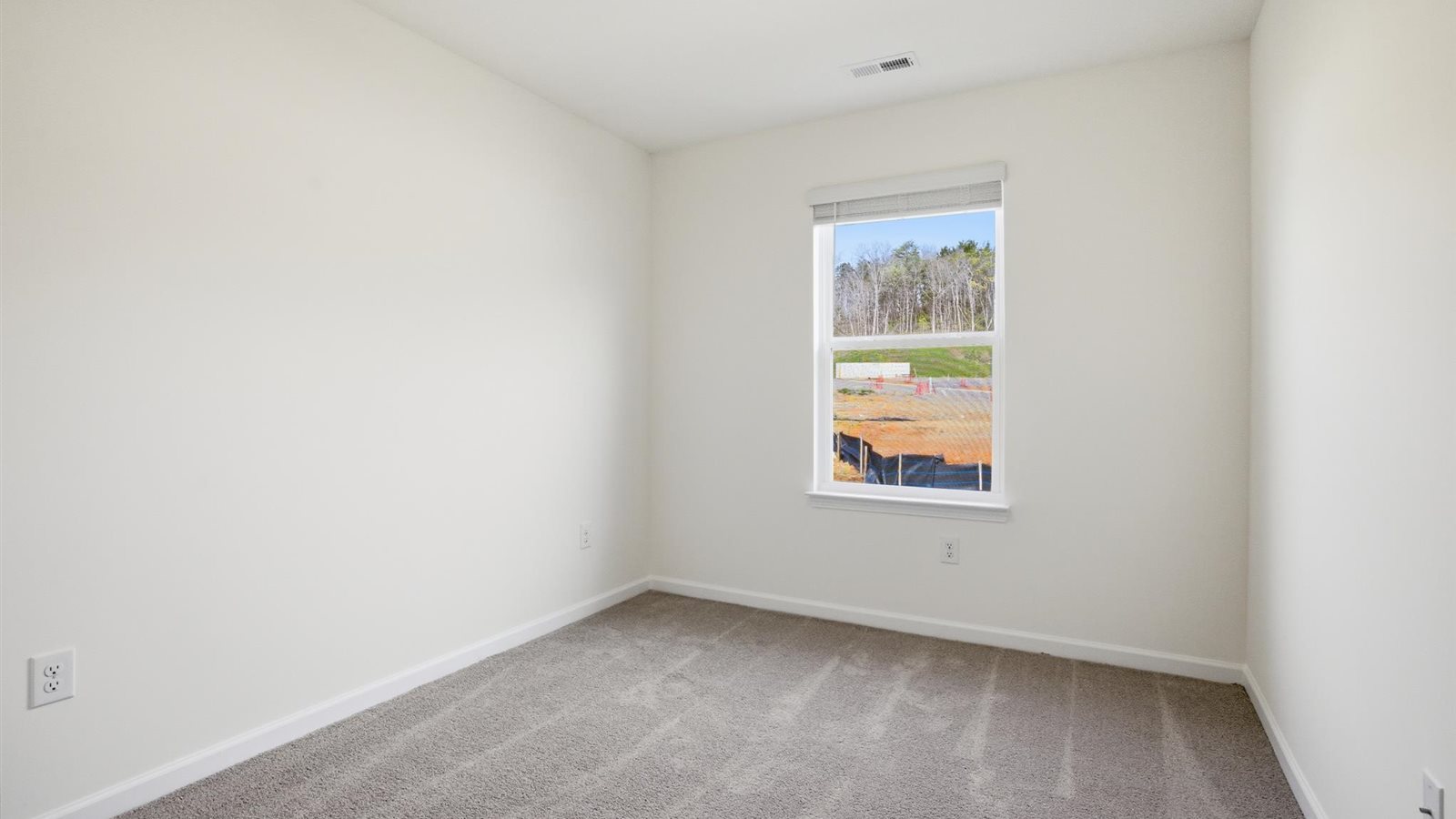 Bedroom with ample natural light and carpet floors