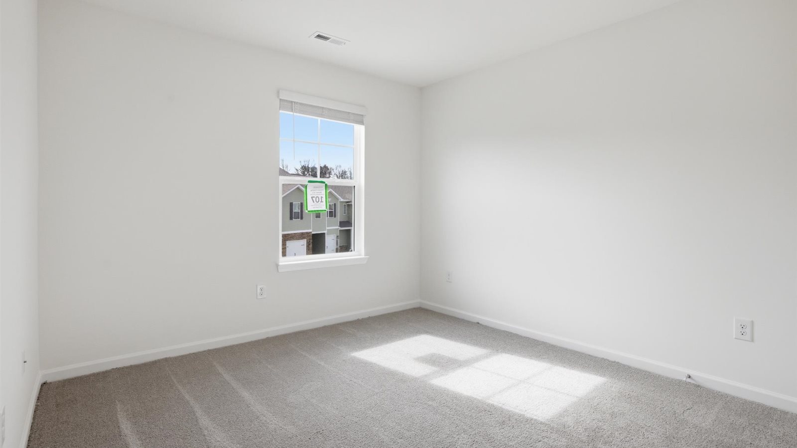 Bedroom with ample natural light and carpet floors