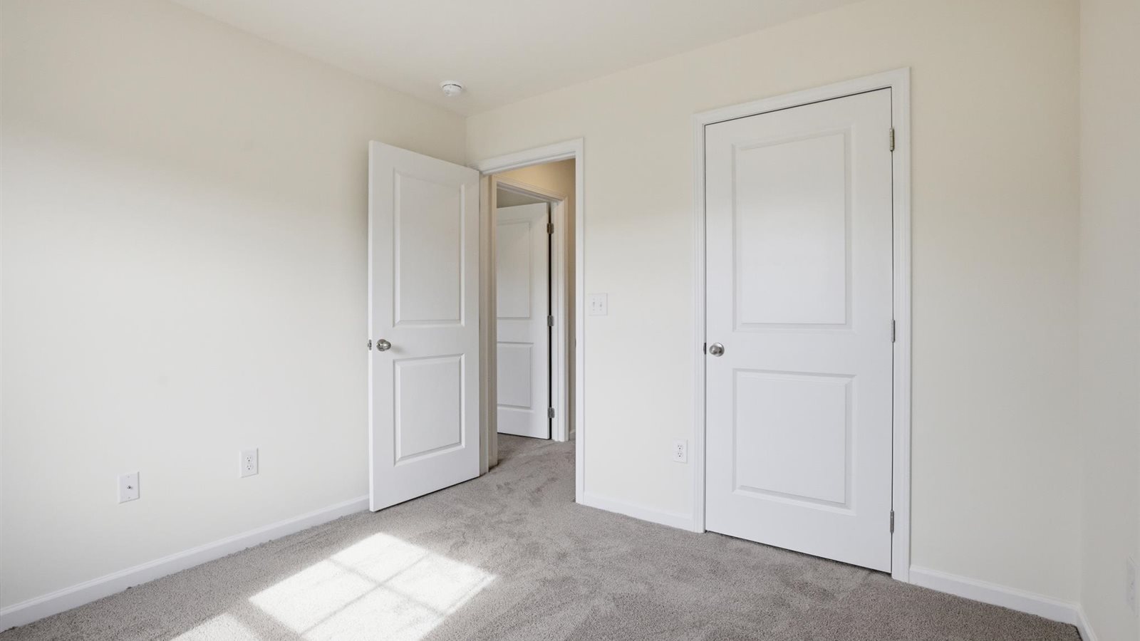 Bedroom with ample natural light and carpet floors
