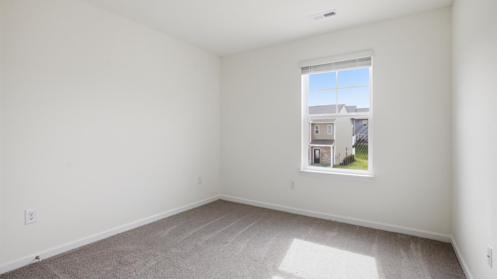 Bedroom with ample natural light and carpet floors