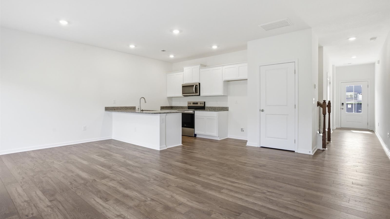 Open concept living, dining, and kitchen space