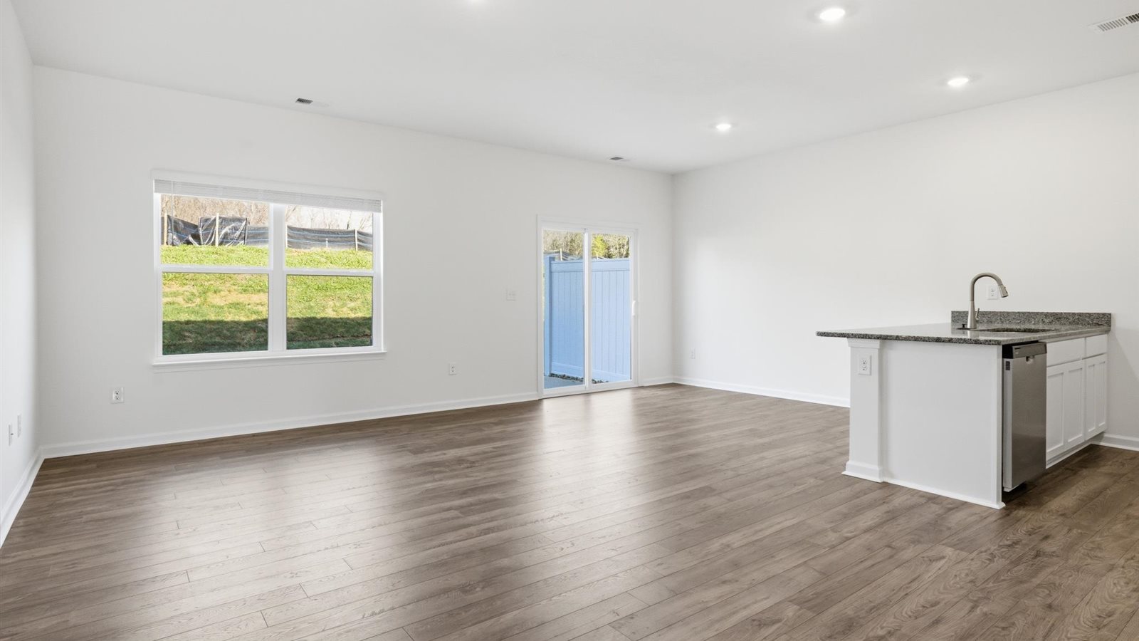 Open concept living, dining, and kitchen space