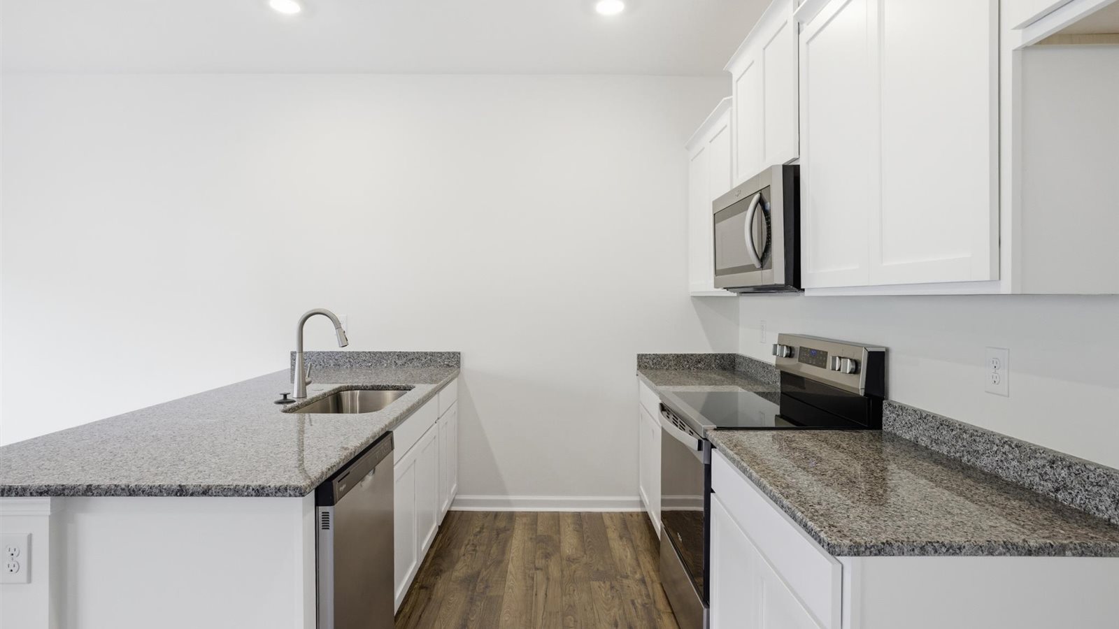 Kitchen with stainless steel appliances, shaker style cabinets, and elevated finishes