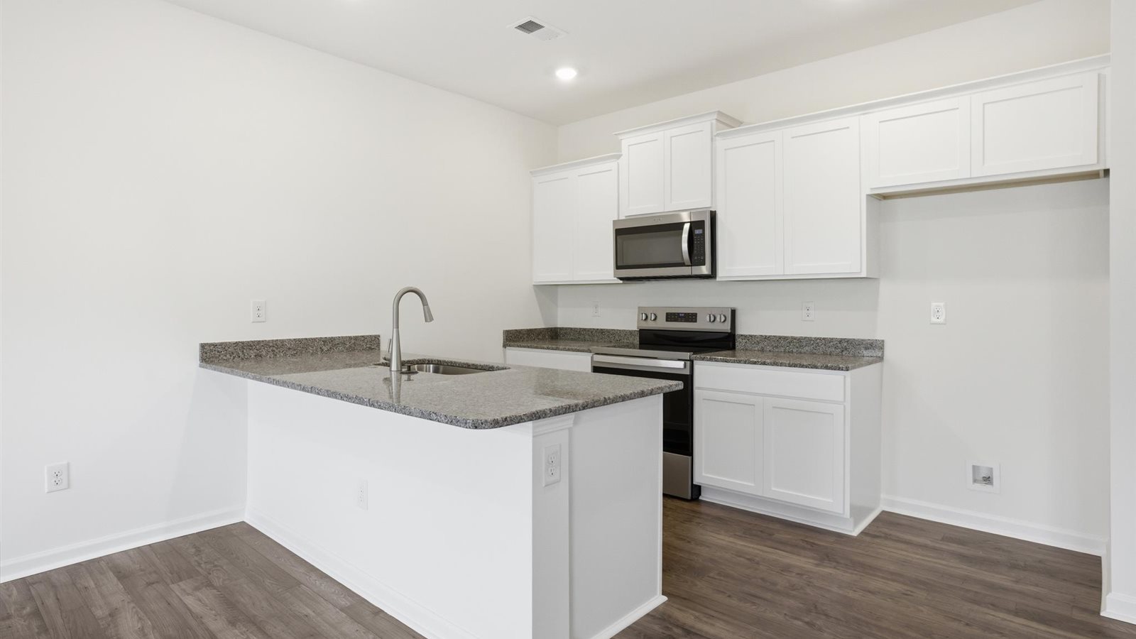 Spacious open concept kitchen with island and counter prep space