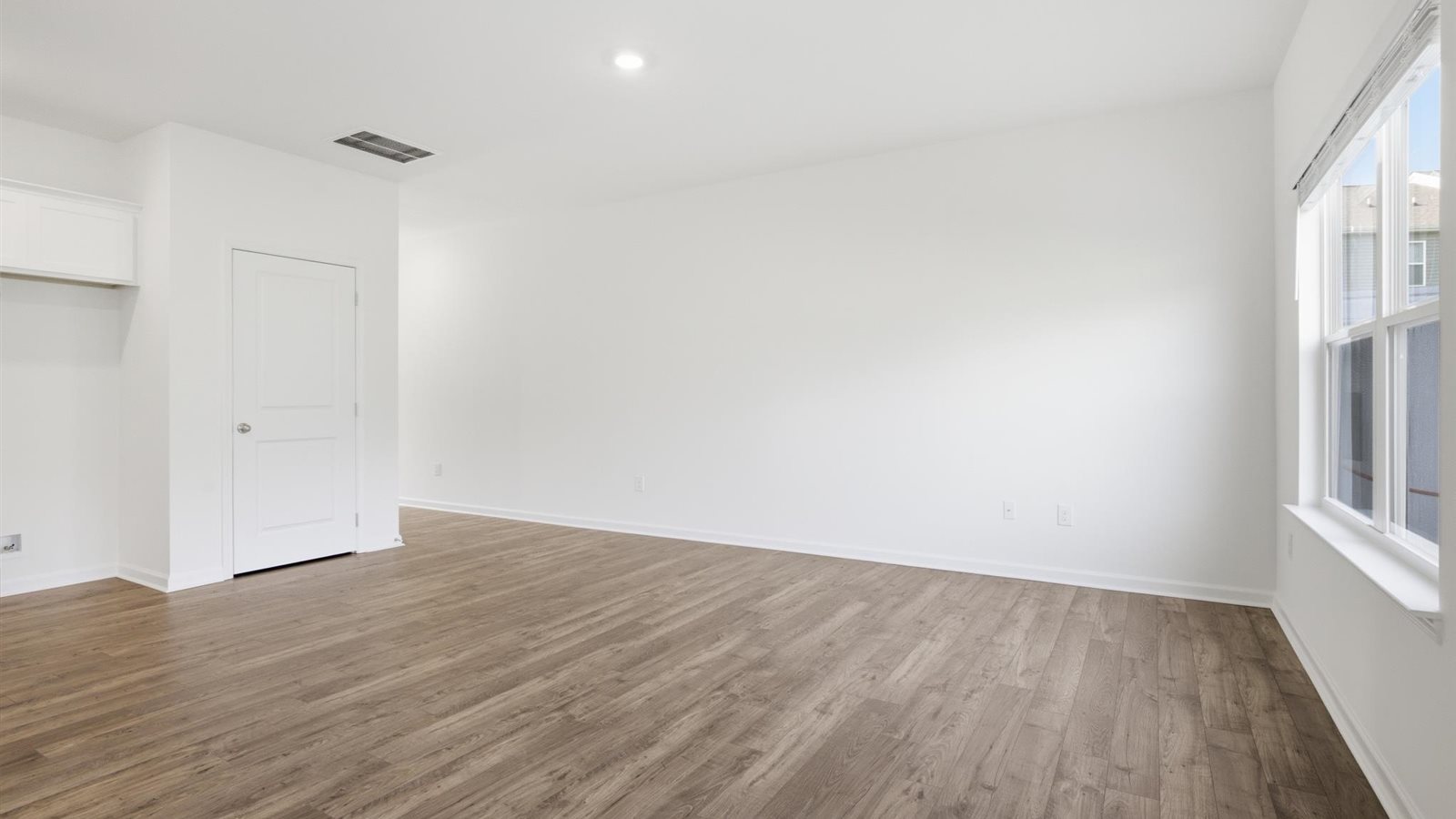 Spacious living and great  room space with light allowing windows