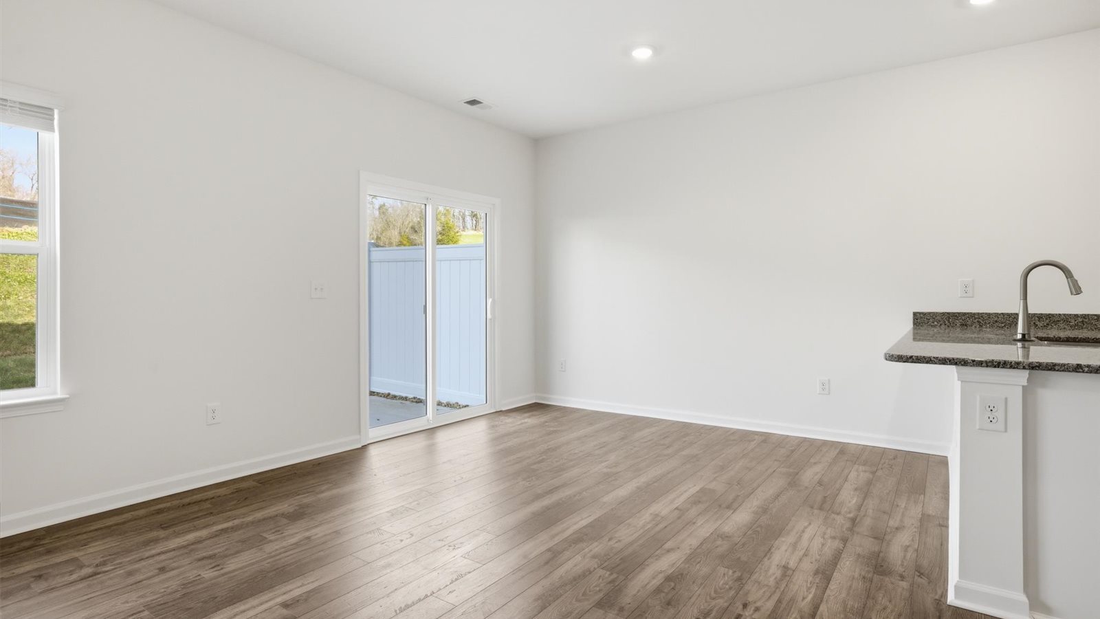 Open concept living, dining, and kitchen space