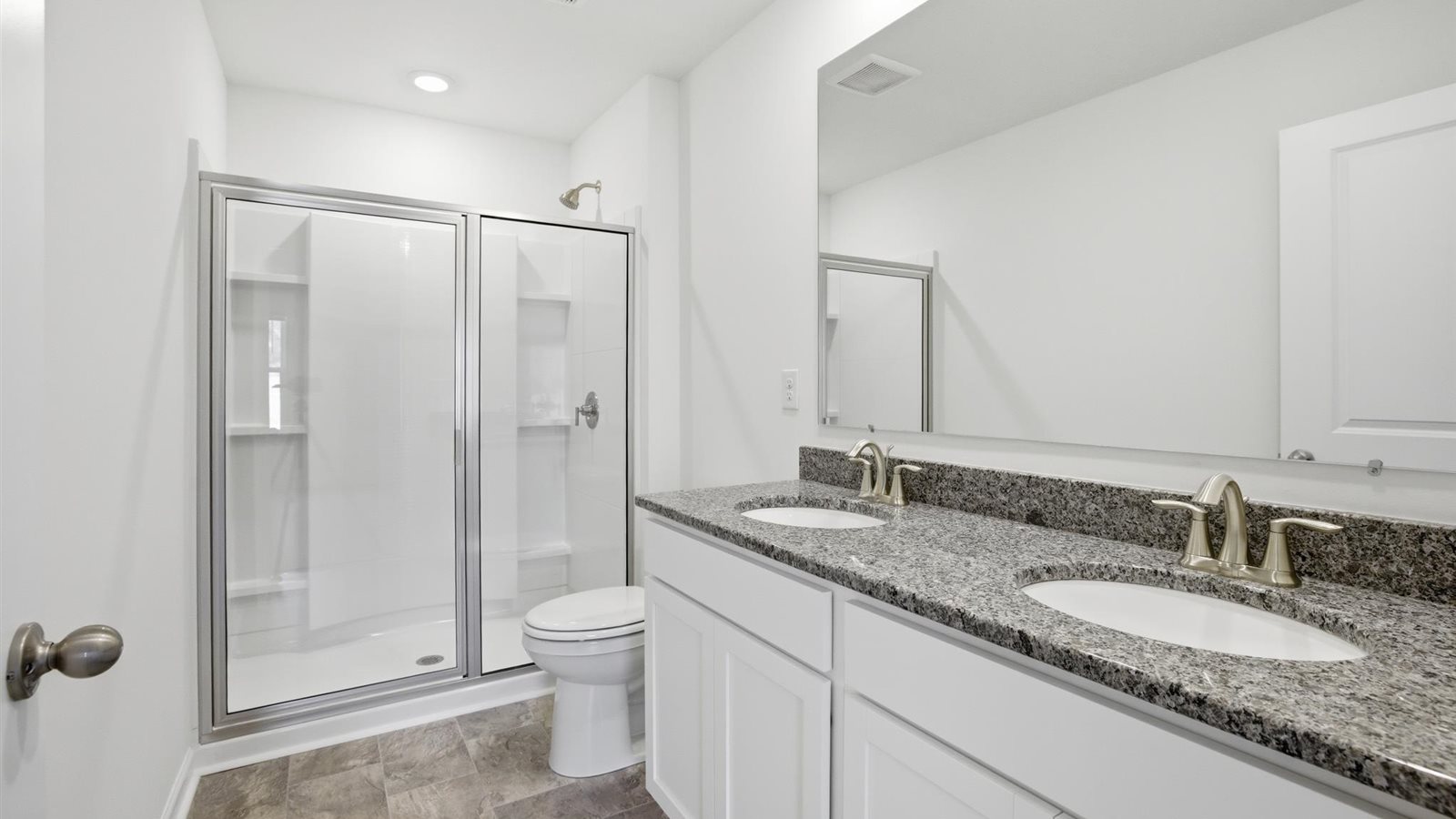 Primary bathroom with double vanity and walk-in shower