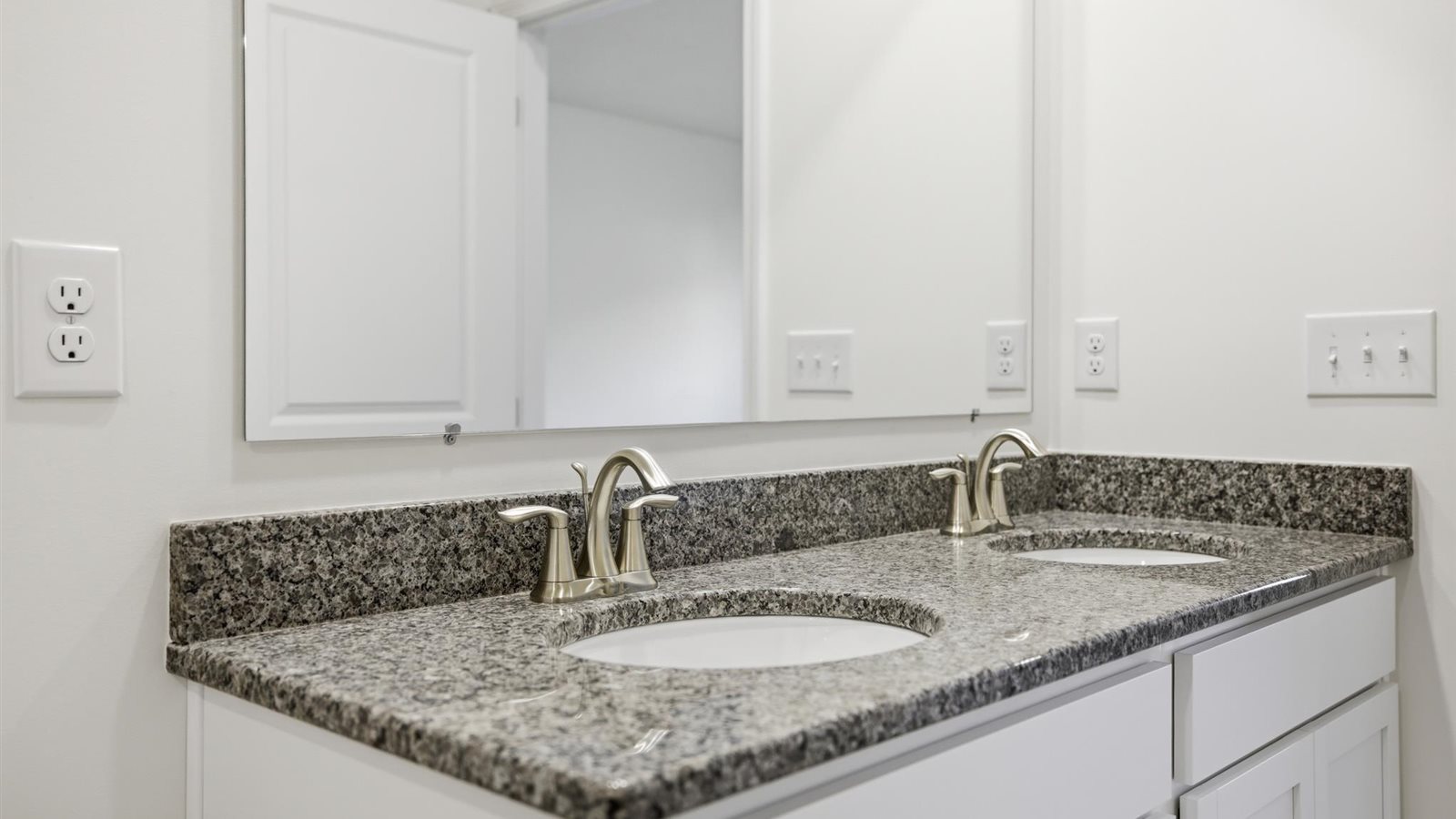 Primary bathroom with double vanity and walk-in shower