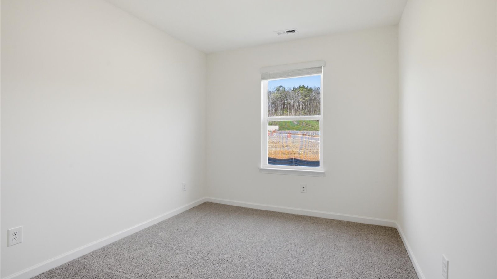 Bedroom with ample natural light and carpet floors