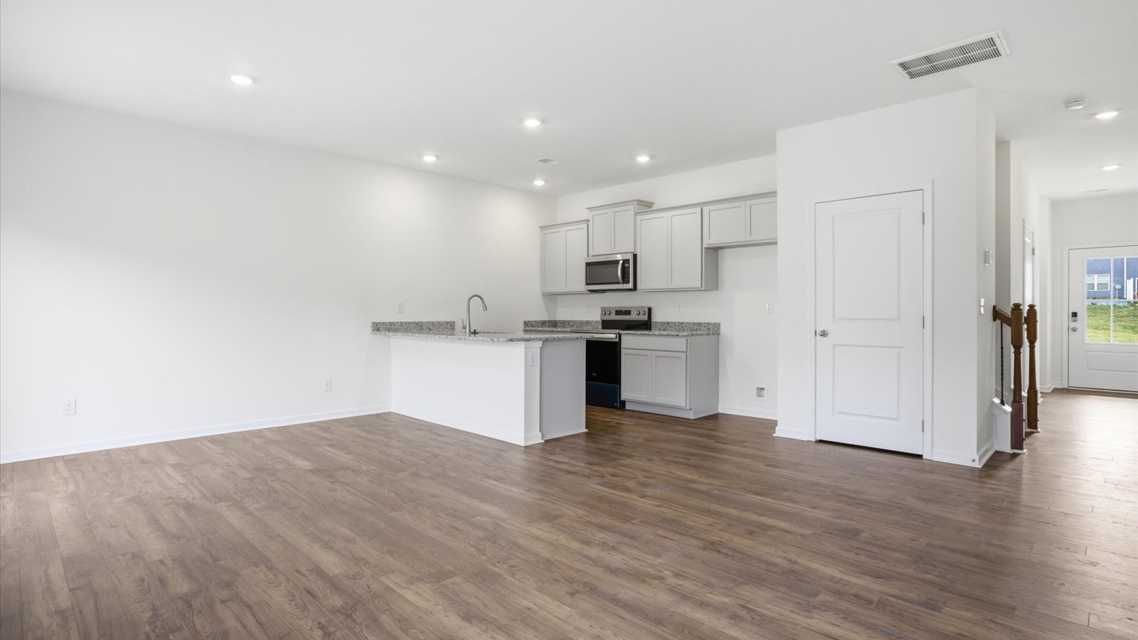 Open concept living, dining, and kitchen space