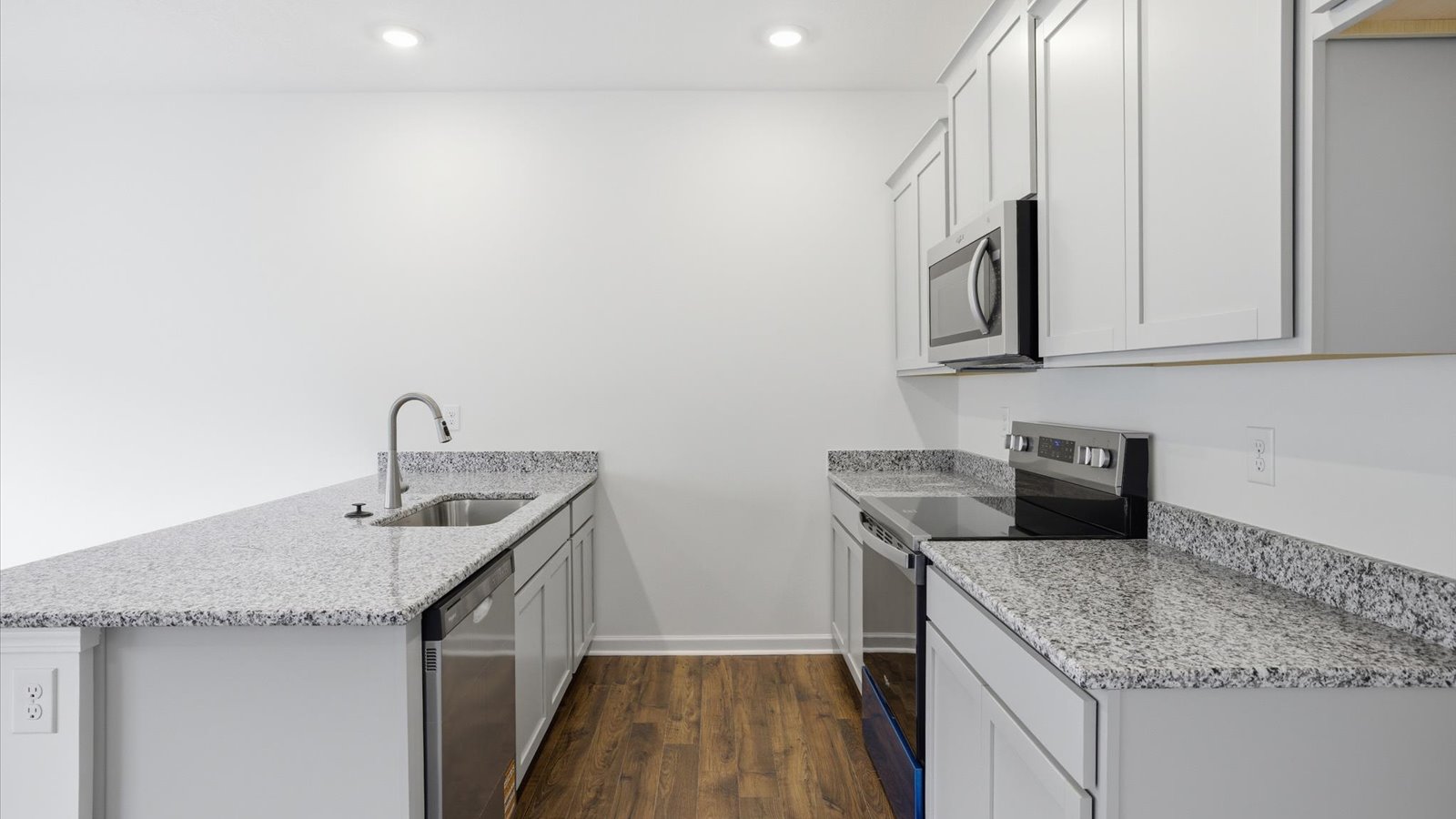 Kitchen with stainless steel appliances, shaker style cabinets, and elevated finishes