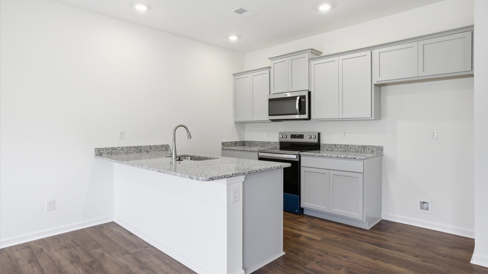Kitchen with stainless steel appliances, shaker style cabinets, and elevated finishes