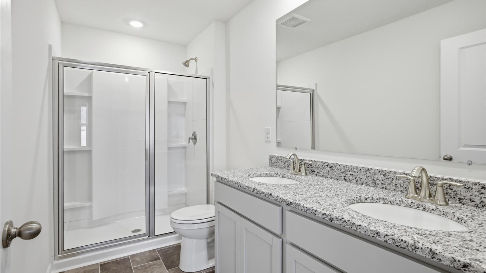 Primary bathroom with double vanity and walk-in shower