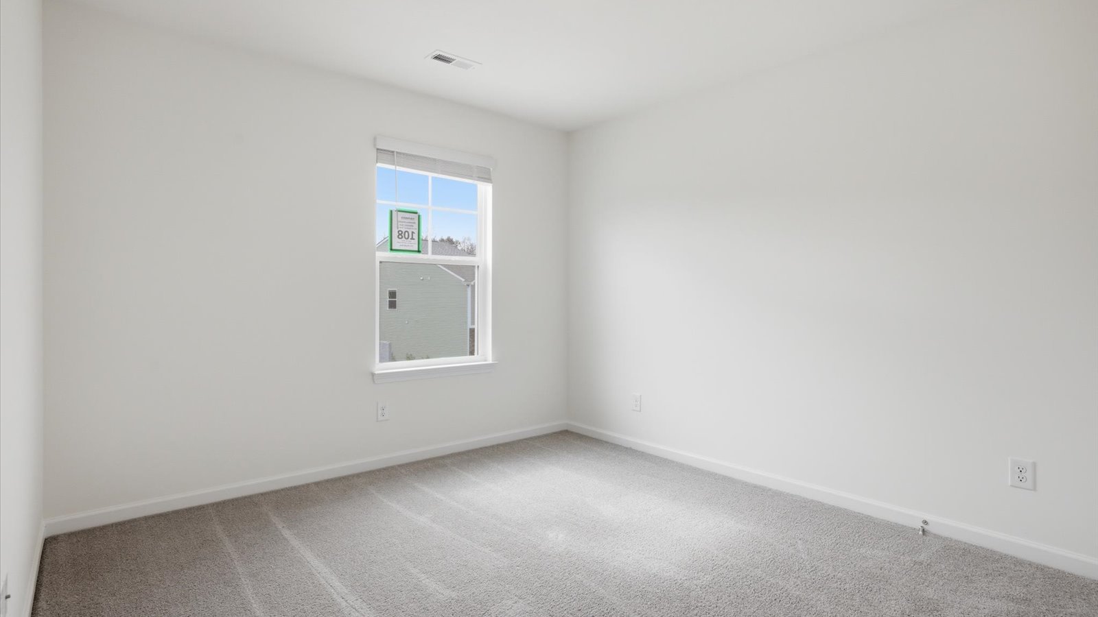 Bedroom with ample natural light and carpet floors