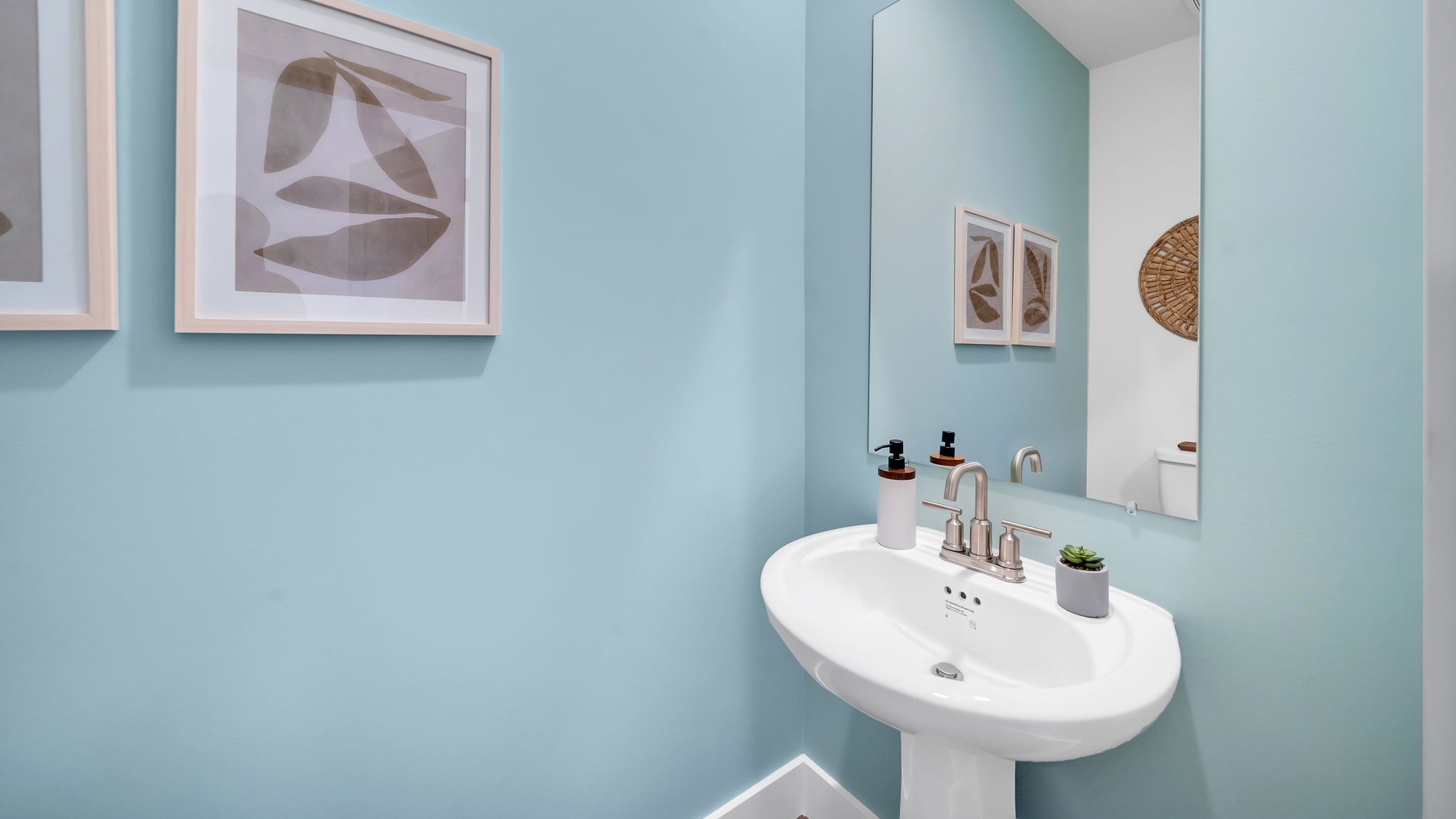 Downstairs guest half bathroom with pedestal sink
