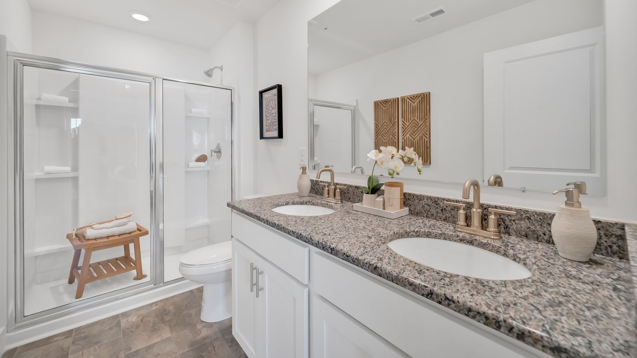Primary bathroom with double vanity and walk-in shower
