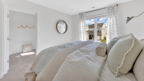 primary bedroom with capret and white walls