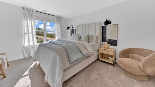 primary bedroom with carpet and white walls