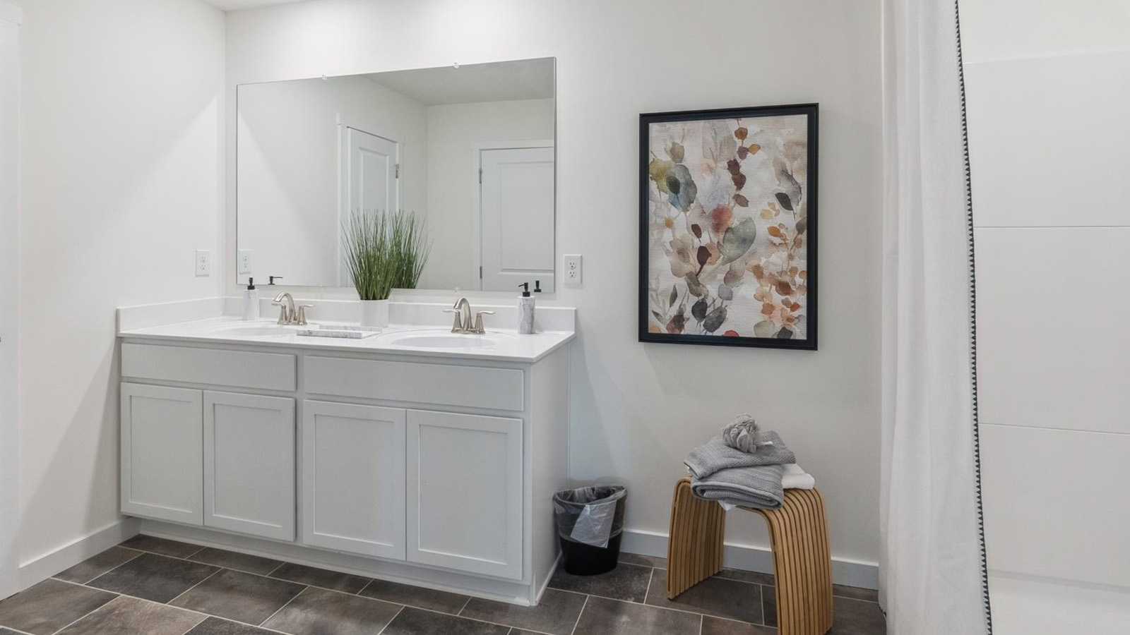 Primary bathroom with double vanity and walk-in shower