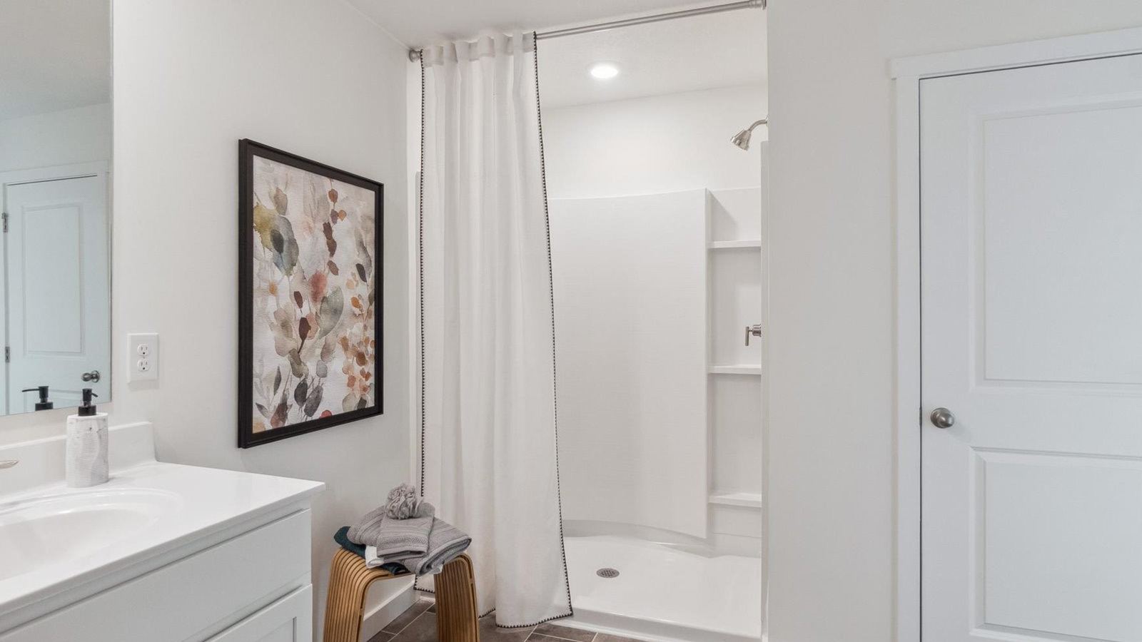 Primary bathroom with double vanity and walk-in shower