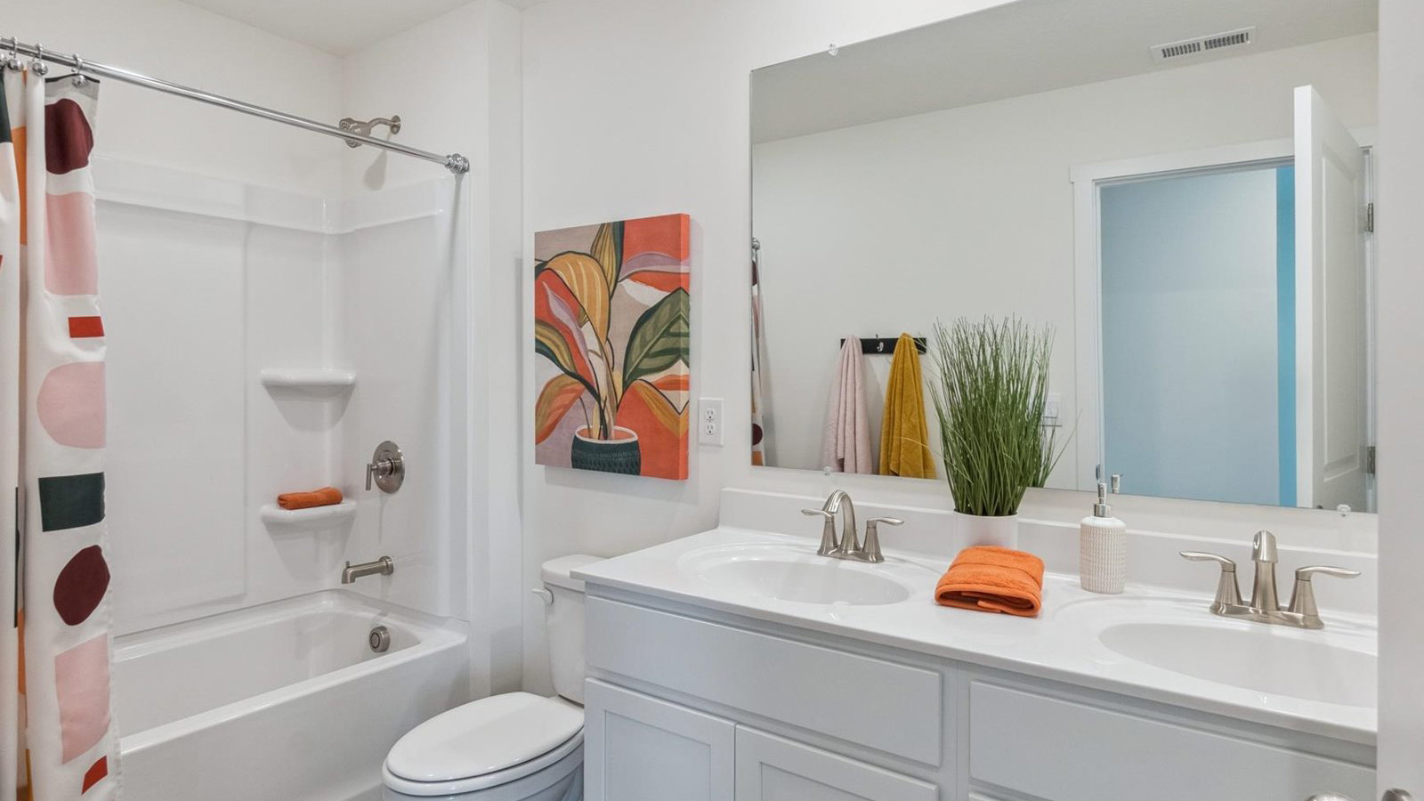 Upstairs guest bathroom with combination shower and bathtub