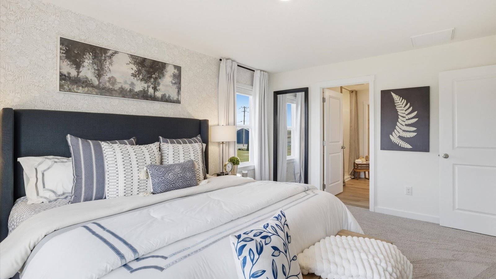 Primary bedroom with private attached bathroom and walk-in closet