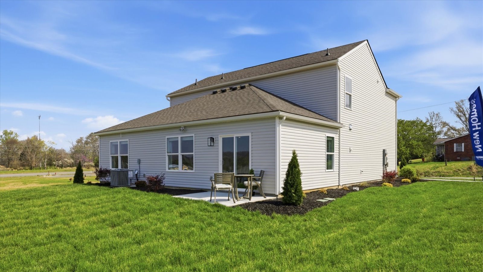 rear exterior of two story home with patio and large back yard