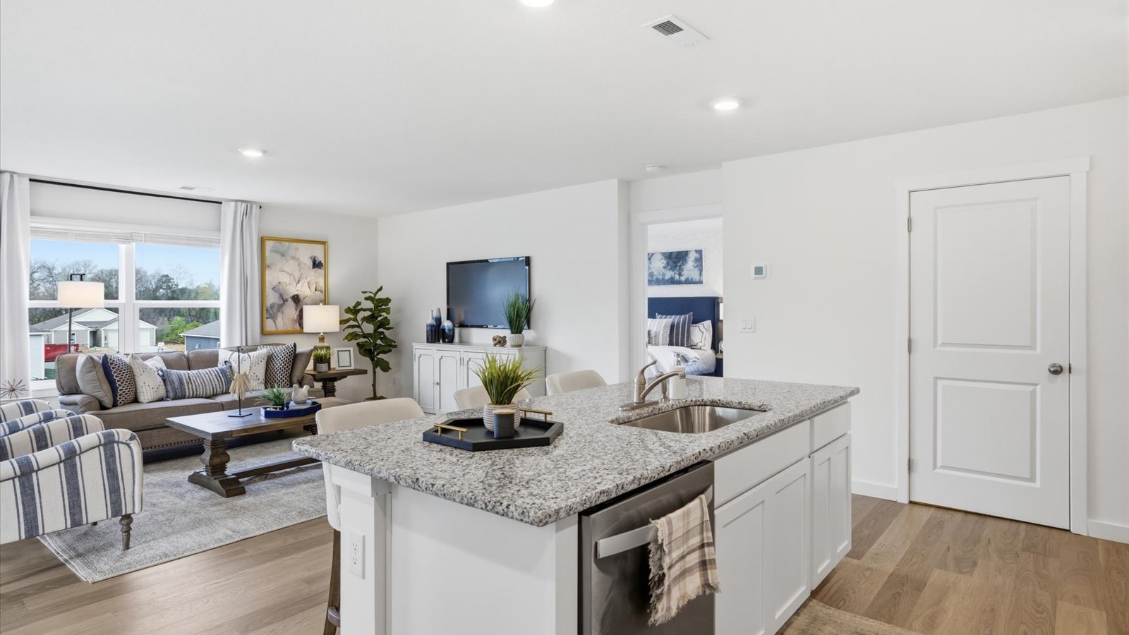 kitchen with stainless-steel appliances, granite counters, kitchen island, and shaker style cabinets