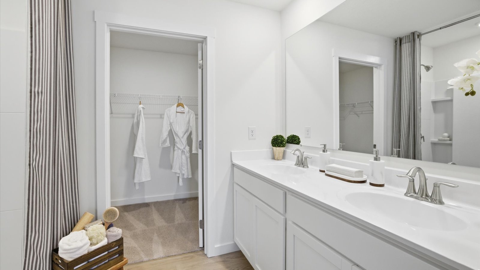 private primary bathroom with walk in shower and double sink vanity