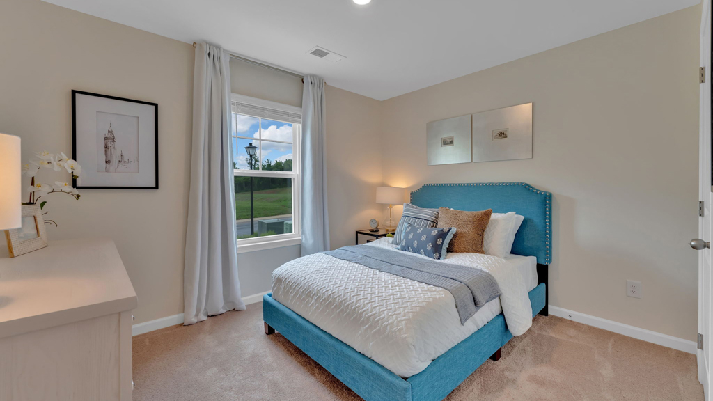 Bedroom with ample natural light and carpet floors