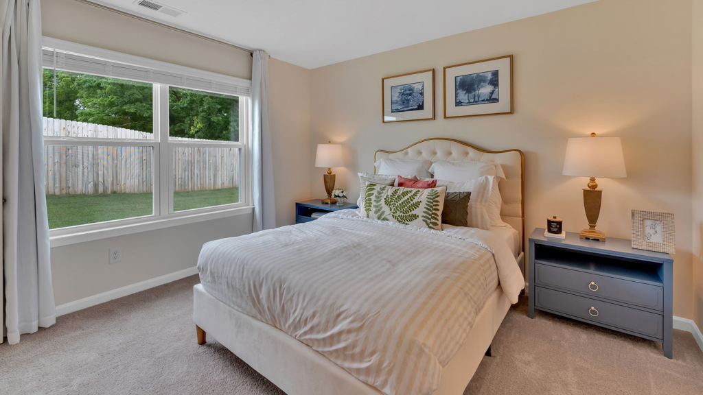 Primary bedroom with private attached bathroom and walk-in closet