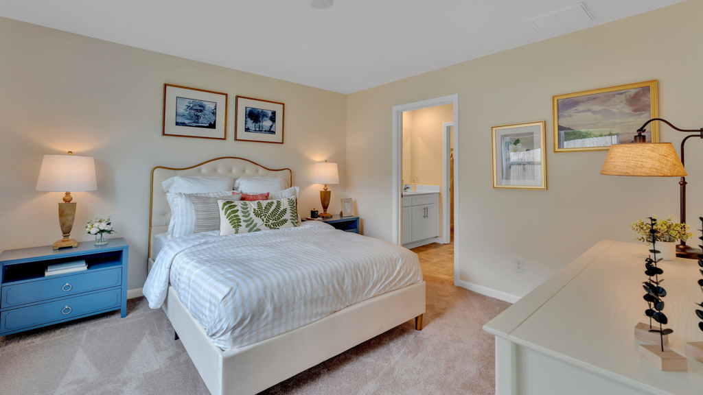 Primary bedroom with private attached bathroom and walk-in closet