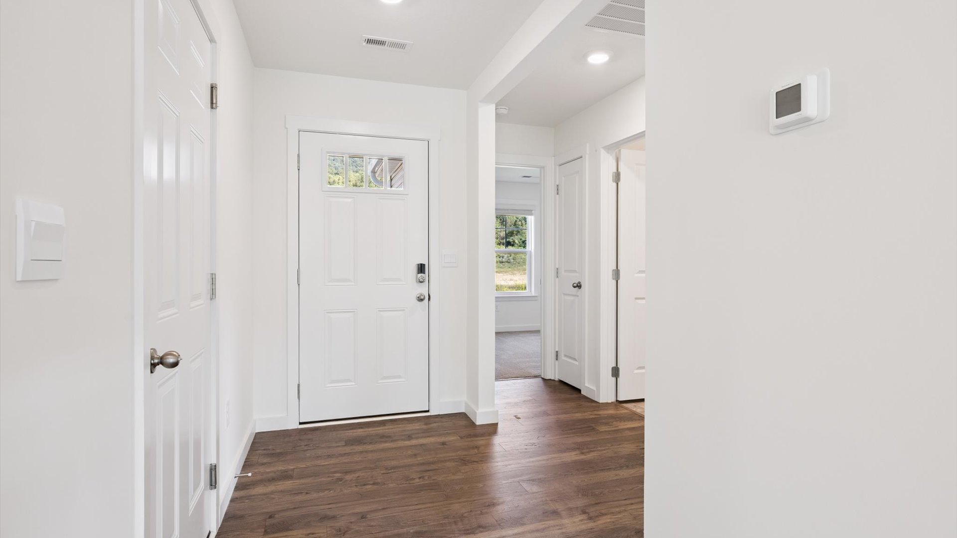 A foyer, entry hall inside front door, next to office, or sitting room adding a welcoming front, direct line of sight to home