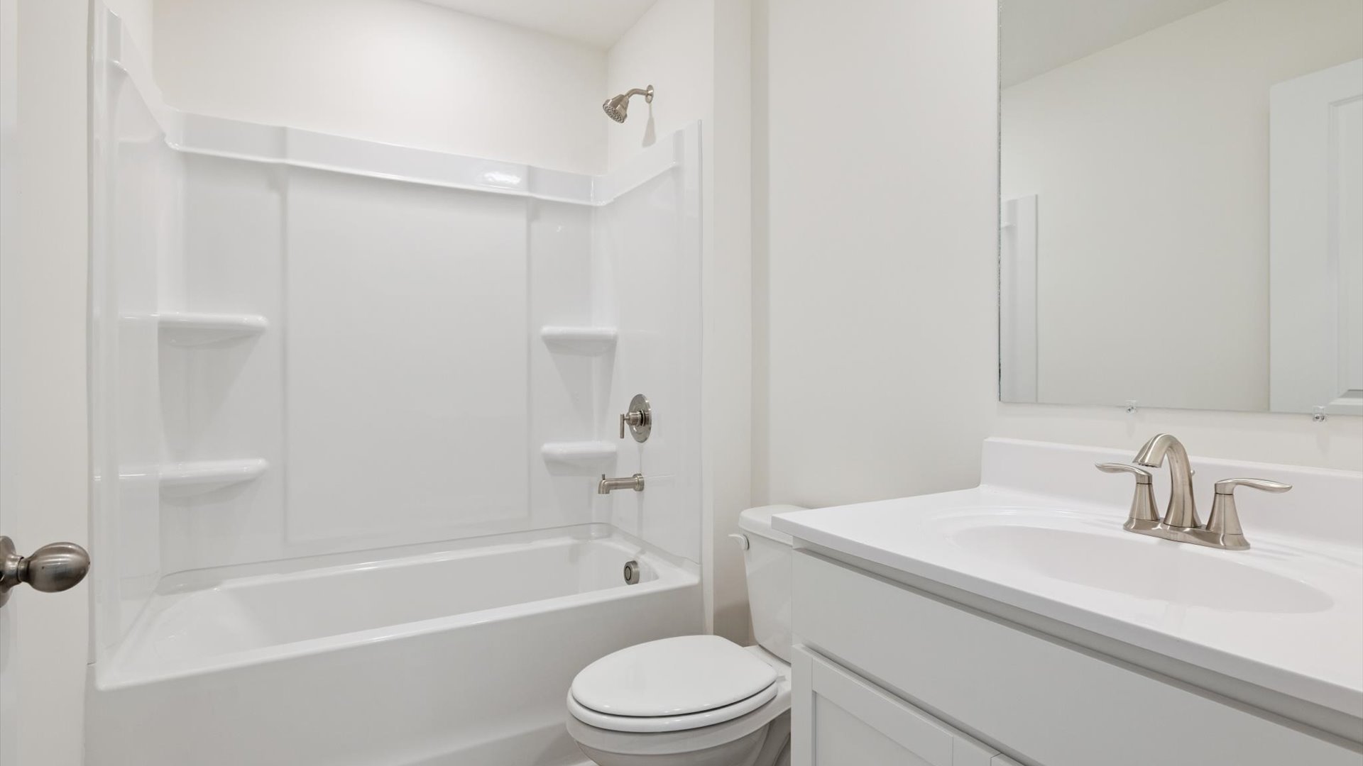 Family bathroom with stylish vanity, mirror, polished fixtures, cabinets, tub-shower combo in Emory Creek