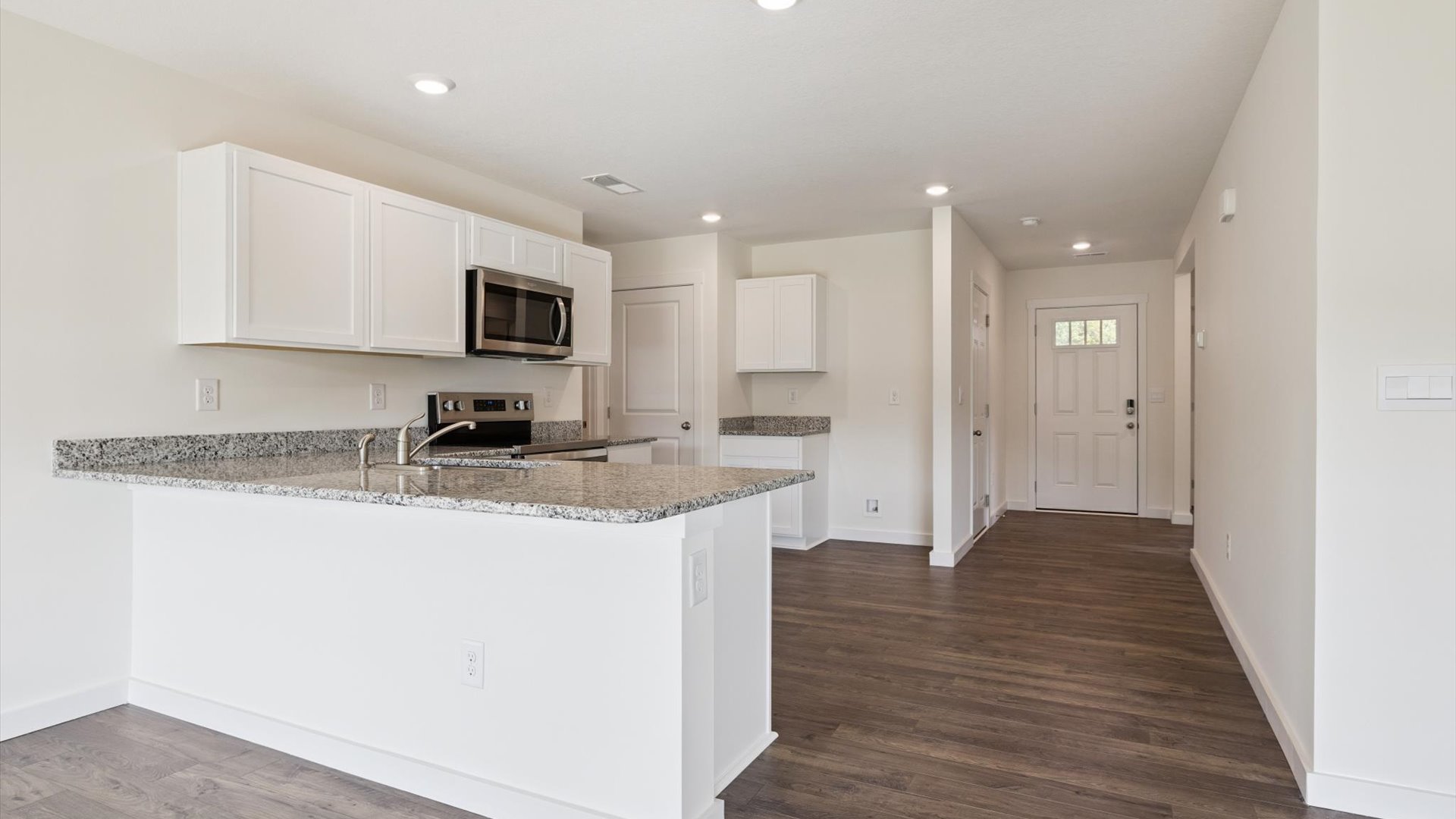 Central kitchen anchors the home adding a dining option, full sink, pantry and storage, multi-prep zones