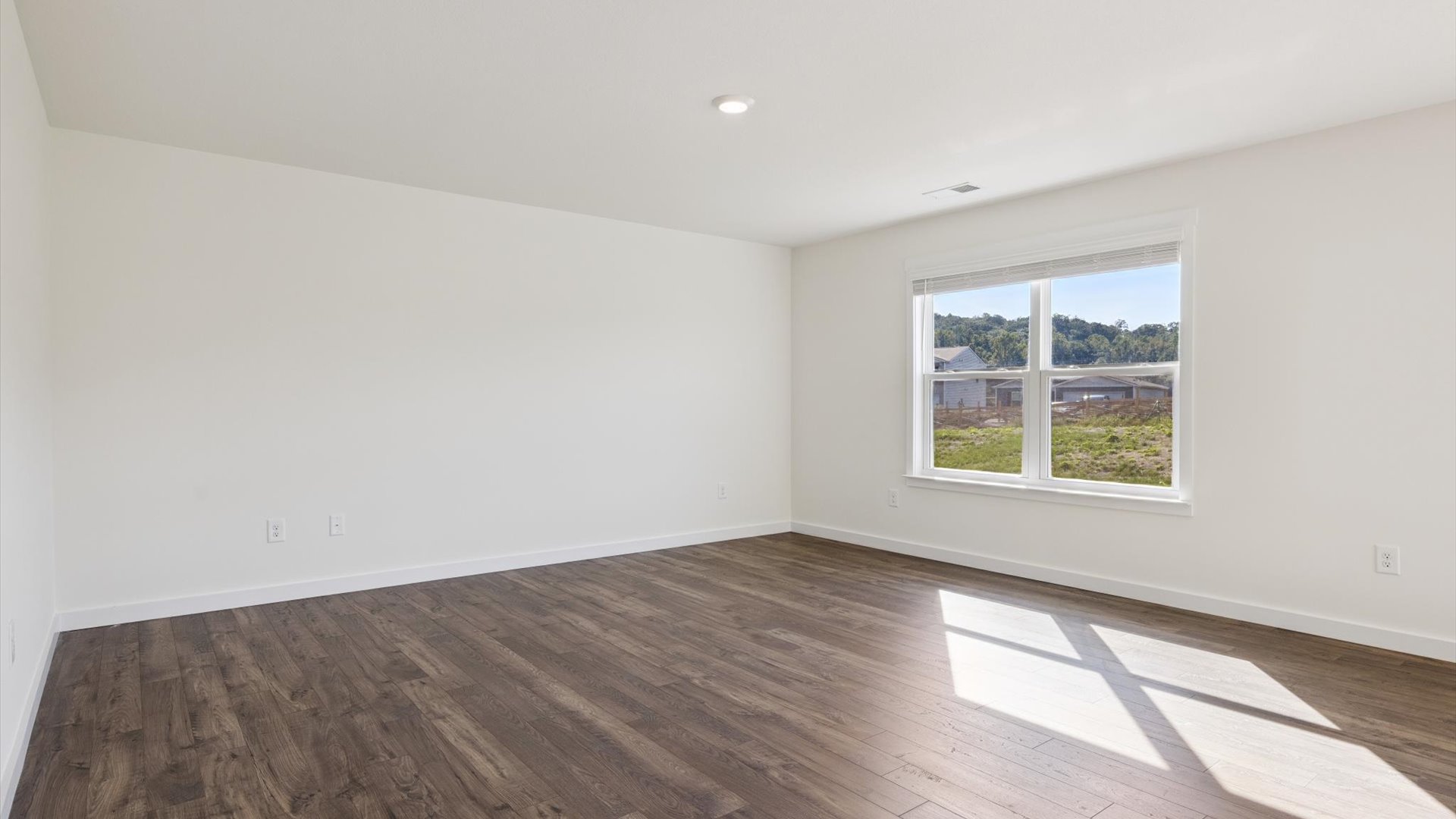 Spacious living room with view into dining and kitchen areas, and upstairs access at Emory Creek