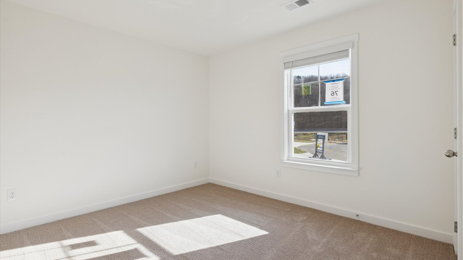 Bedroom with ample natural light and carpet floors