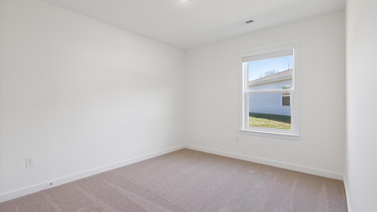 Bedroom with ample natural light and carpet floors