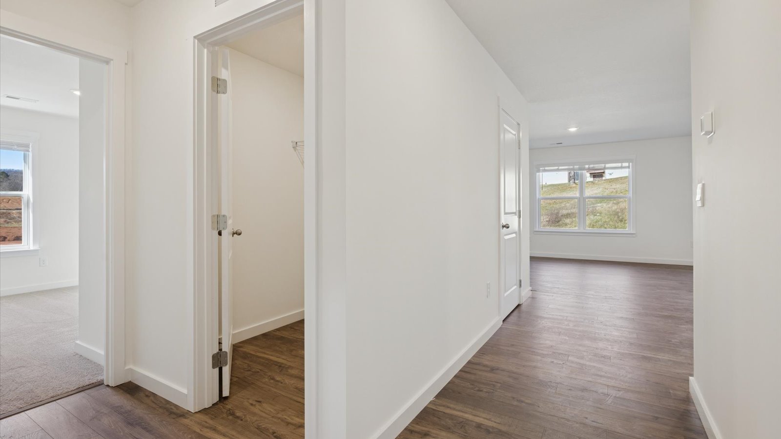Bright hallway with hardwood flooring