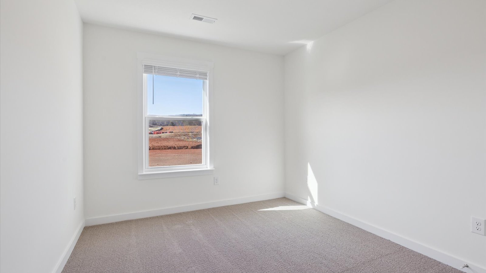 Bedroom with ample natural light and carpet floors