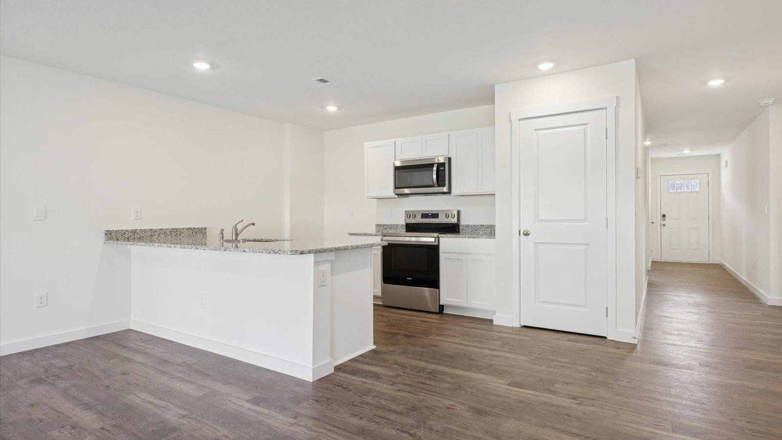 Open concept living, dining, and kitchen space