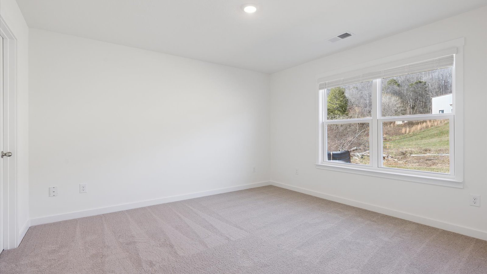 Bedroom with ample natural light and carpet floors