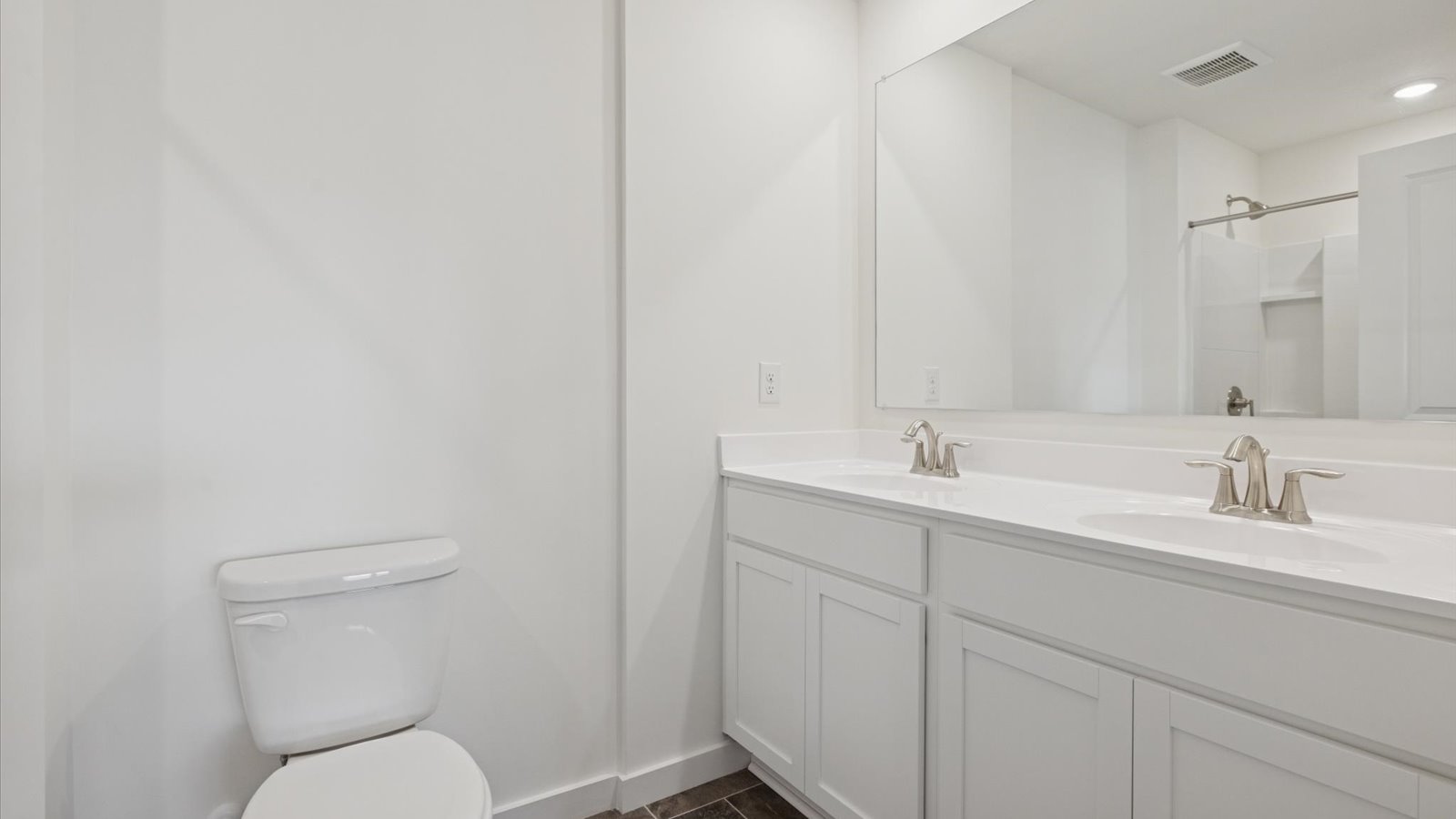 Primary bathroom with double vanity and walk-in shower