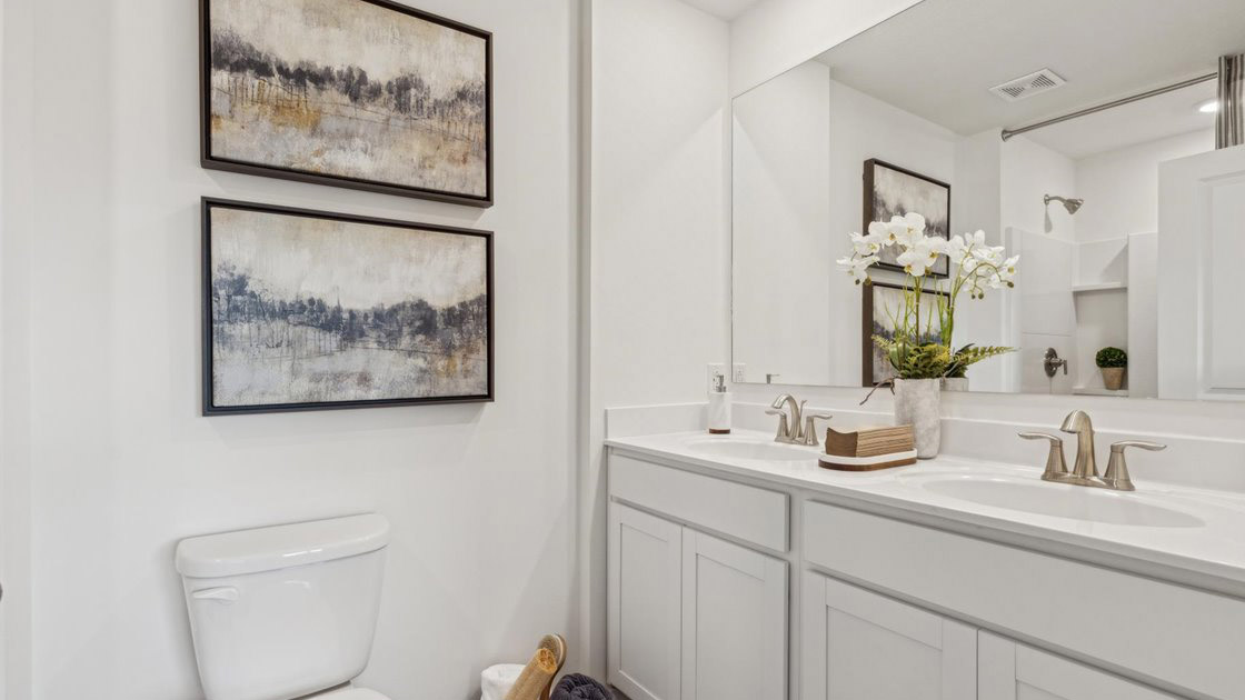 Primary bathroom with double vanity and walk-in shower