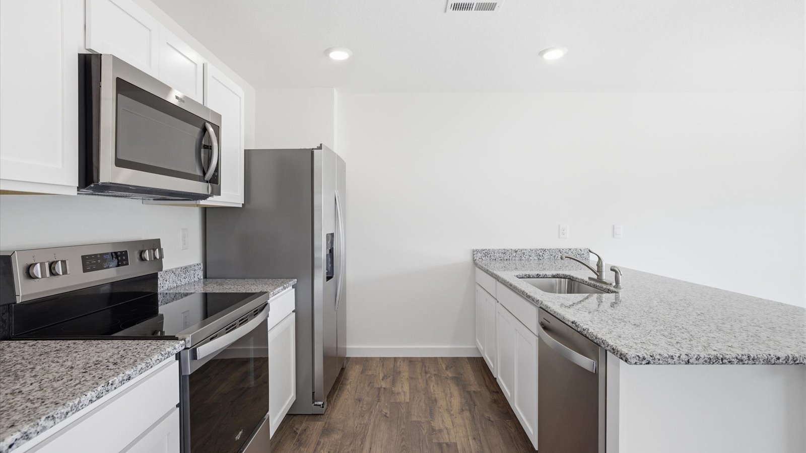 kitchen with refrigerator microwave electric range and dishwasher