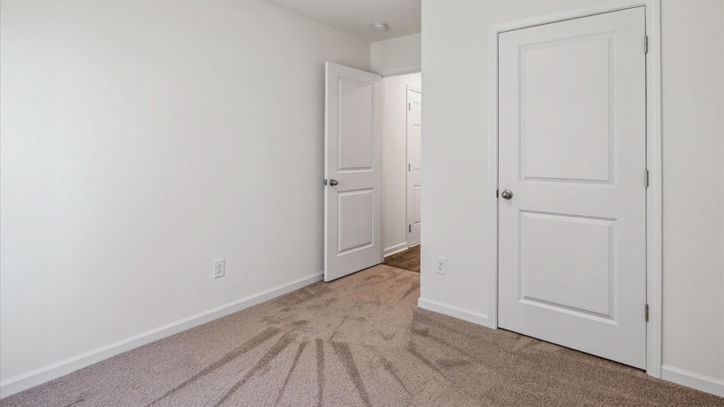 Second bedroom in Emory Creek includes natural window light, full closet, connectivity to the residence