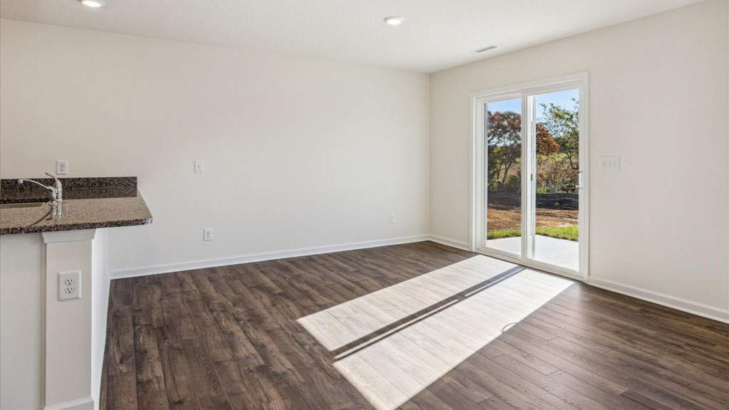 View from kitchen into the dining and living rooms, backyard area with outdoor access to patio at Emory Creek